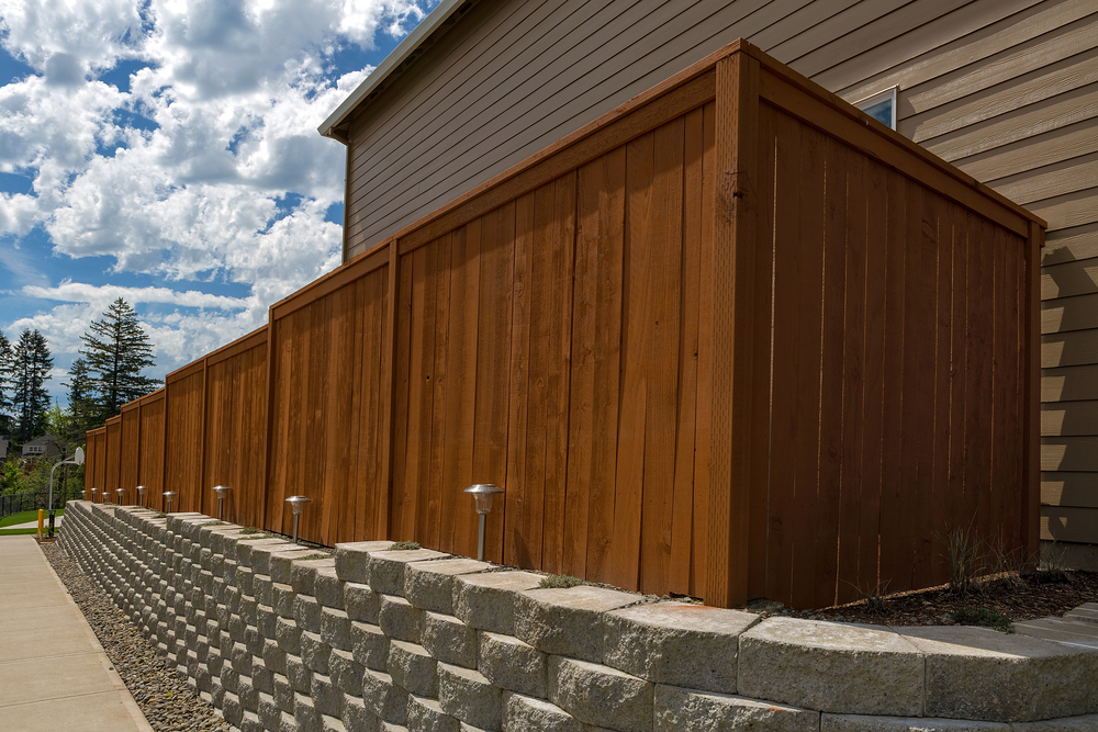 Wood,Fence,Cement,Stack,Stone,Blocks,Retaining,Wall,And,Landscaping